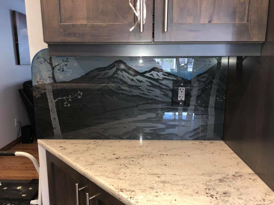 custom glass kitchen backsplash with a mountain motif